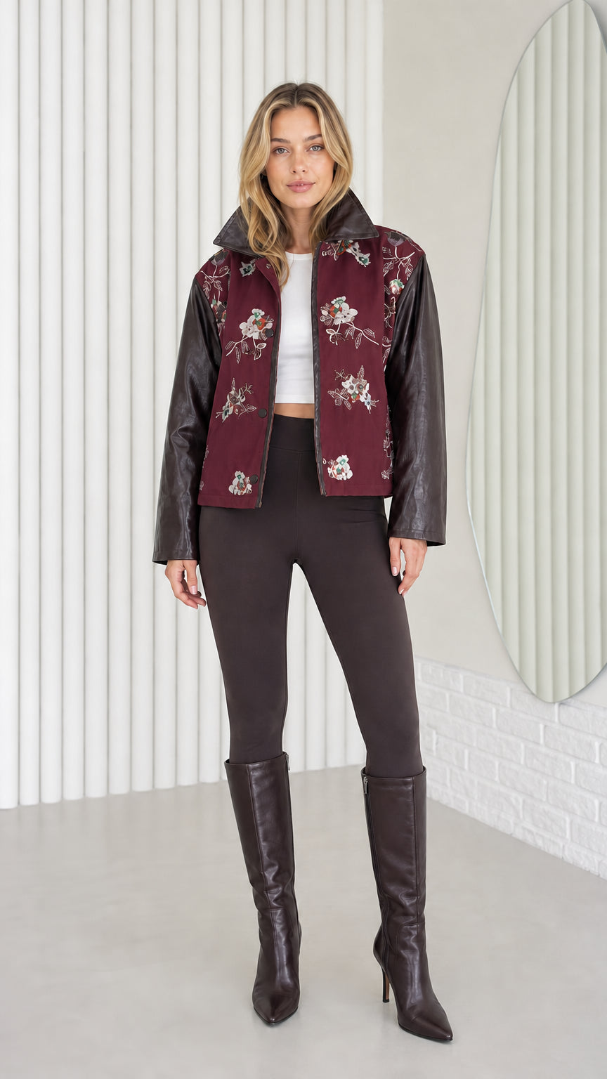 Model wearing Burgundy embroidered jacket with faux leather sleeves