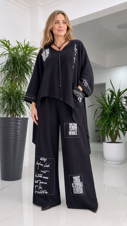 Front view of woman wearing black typography print two-piece pant set
