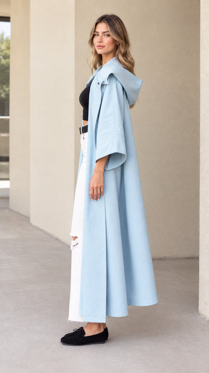 Side profile view of sky blue longline hooded trench coat