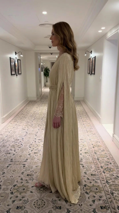Side profile view of Champagne Gold pleated maxi dress showing split cape sleeves
