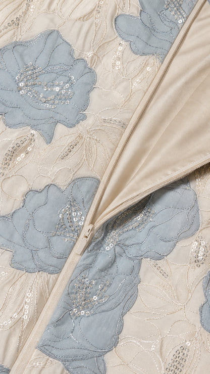 Close-up detail of floral embroidery, sequins, and side zipper