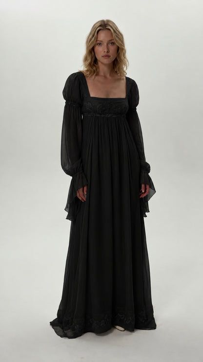 Front view of model wearing black empire waist chiffon maxi dress