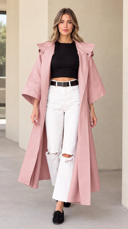 Front view of woman wearing dusty pink hooded maxi duster coat
