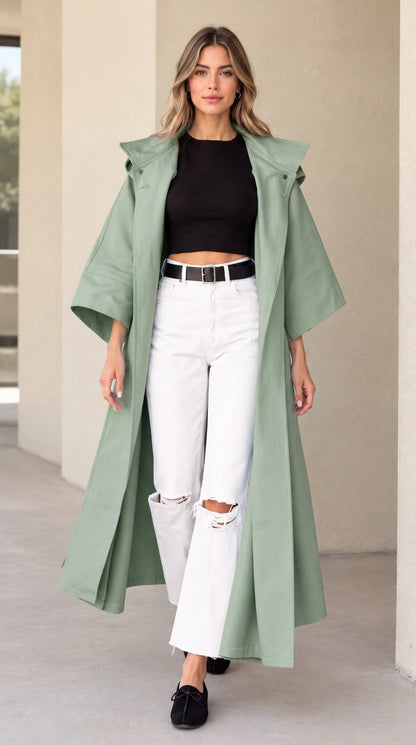 Front view of woman wearing sage green hooded maxi duster coat