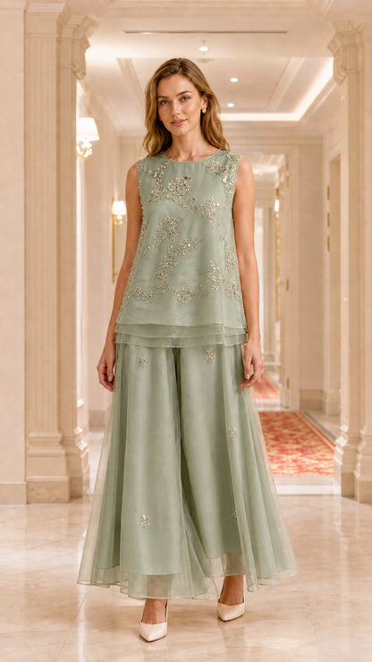 Model wearing sage green embroidered sleeveless tunic and wide-leg pant set